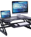 32 Inch Height Adjustable Standing Desk Converter With Slide Out Keyboard Tray And Dual Monitor Riser on a black frame, showcasing dual monitors and keyboard.