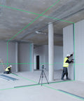 Two contractors using Boss Class 12V Max Three Plane Green Beam Laser Level for alignment in a construction site.