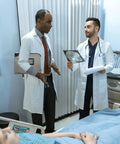 Doctors discussing a patient's x-ray in a hospital, showcasing teamwork and medical expertise in a clinical setting.