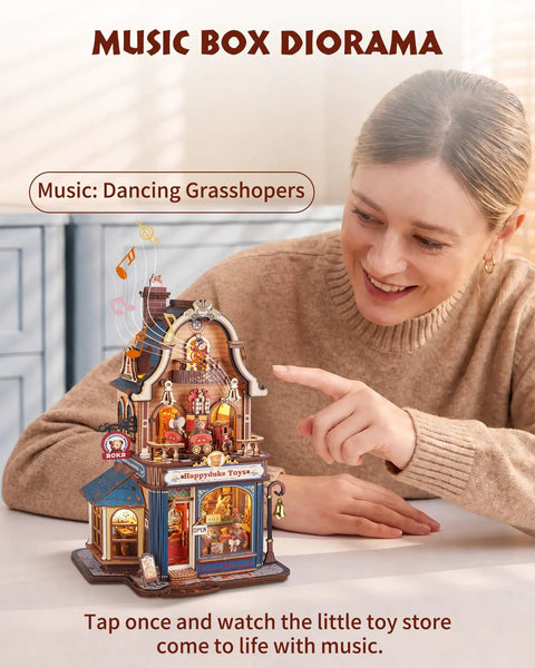 Hands-On DIY Miniature House Kit With Moving Scenes Music Box And LED Light, 3D Wooden Puzzles For Book Nook Tiny Home Decor, Kinetic Model Building Kit Type C Powered, Gift For Adults And Craft Lovers, woman pointing at toy shop diorama