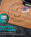 Personalized wooden cutting board, front view, laser-engraved circular name and date.