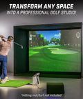 Golfer using 10 By 8 Foot Golf Simulator Enclosure Net With Frame And HD Impact Screen Kit in home studio, not hitting mat.