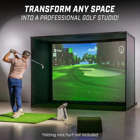 Golfer using 10 By 8 Foot Golf Simulator Enclosure Net With Frame And HD Impact Screen Kit in home studio, not hitting mat.