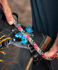 Foot Ascender With Toothless Dual Cams For Reduced Wear And Drag On Climbing Line Use On Either Foot Self Tending Design attached to boot