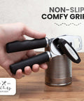 Person using Comfy Manual Can Opener With Bottle Opener, Rust Proof Stainless Steel, Turn Knob, Soft Grip Handles on a can