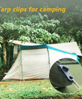 Heavy Duty Tarp Clips With Lock Grip 16 Pack Tarp Clamps securing tent canopy in forest setting.