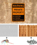 Real Deal Heavy Duty Reflective Aluminum No Trespassing Signs 8 Pack Large 10x7 Orange Private Property warning sign on stone wall.