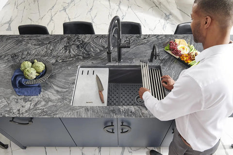 Man placing Silicone Bottom Grid Sink Mat For RVG1033 And RVG2033 Single Bowl Epigranite Sinks Gray in kitchen sink