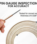 Front view: hand holding cut end of copper-nickel brake line coil, 25 ft, 3/16 in diameter, .028 in wall, with fittings