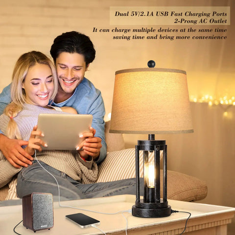 Couple enjoying a modern black table lamp with USB ports and AC outlet by a beige sofa, illustrating dual charging features.