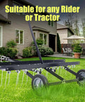 Tow Behind 40 Inch Dethatcher With 20 Spring Steel Tines For Large Lawns, shown on a lawn in a residential backyard