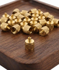 Professional Grade Beefy Brass Refrigeration Valve Caps With Slick Knurled Nozzles For Ac Systems And Coolant Lines Leak Proof Field Service Covers No Sweat Maintenance 30 Pack on a wooden tray.