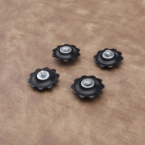 4X 10T Bicycle Gear Mech Pulley Jockey Wheel Kit Universal For 5,6,7,8 Speed Derailleur, black pulleys on brown background