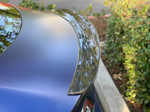 Real Molded Carbon Fiber Matte Dry Look Spoiler For Tesla Model 3, side view showcasing aerodynamic design and glossy finish.