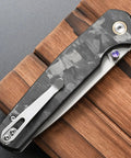 Folding Knife With 14C28N Steel Blade And Carbon Fiber Handle Go To EDC Knife With Pocket Clip, closed view on wooden surface