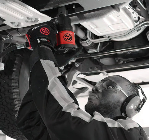 1/2 Inch Air Impact Wrench Packin 960 Ft Lbs Of Raw Torque For Heavy Duty Wheel Removal And Quick Tire Swaps Weighs Just 4.4 Lbs in use under a vehicle.