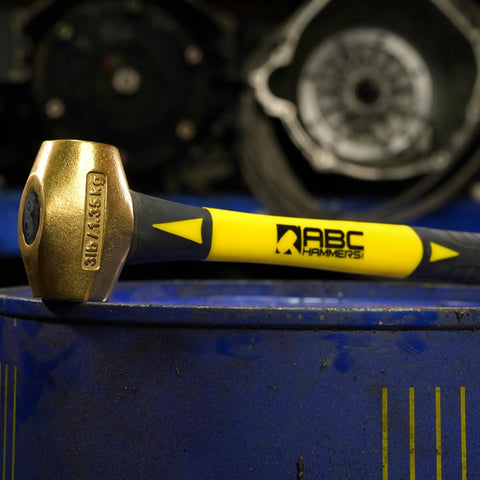 Non-Sparking 16-Inch Brass Hammer With Fiberglass Handle 5-Lb Double-Faced USA Made on blue barrel in auto shop