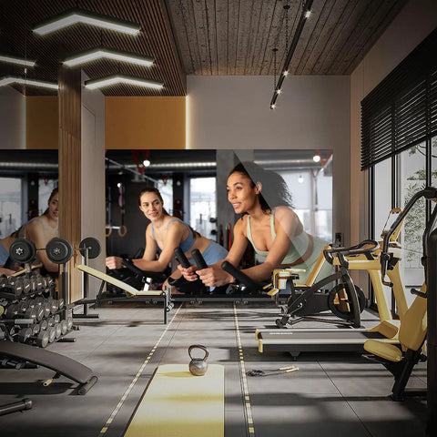 80 Inch Foldable Led Display Featuring Seamless Splicing P1.86 Pixel Pitch Digital Signage Totem in a gym setting with workout equipment.