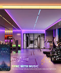 5V USB RGB COB LED Strip Light 4.92ft color changing tape with Bluetooth control in a modern gym, multicolor backlight effect.