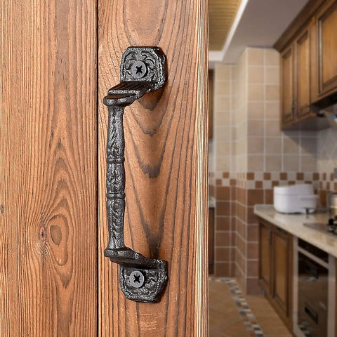 Four Pack Cast Iron Sliding Barn Door Handles 5.51 Inch Dark Brown Vintage Metal Pulls mounted on wooden door in kitchen