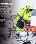 Person wearing High Visibility Reflective Winter Safety Jacket Insulated Parka ANSI Compliant Lime Large GloWear 8384 working in snow.