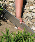 Person installing Aluminum Landscape Edging Kit For Lawn And Garden 8 Edging Pieces With Spikes 48 Feet Total Black Rustproof