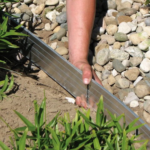 Person installing Aluminum Landscape Edging Kit For Lawn And Garden 8 Edging Pieces With Spikes 48 Feet Total Black Rustproof