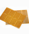 Two stacked 20 Piece 5 By 7 Cm Yellow Universal Breadboard Prototyping Boards Single Sided Bakelite Circuit Boards for electronics.