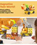 Kids playing with Magnetic Construction Vehicle Tiles Set 5 In 1 Buildable Crane Excavator Dump Truck on a tabletop.