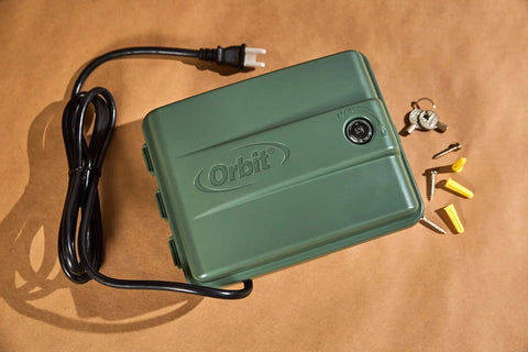 Four Station Outdoor Sprinkler Timer With Swing Panel For Lawn Care, shown with power cord, screws, and weatherproof cabinet