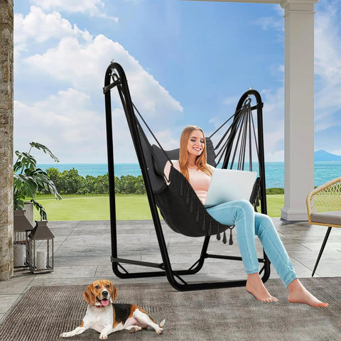 Woman relaxing on U Shaped Hammock Chair With Stand For Indoor Or Outdoor Relaxation Sturdy Rust Resistant Cozy Gray Cotton Swing Chair No Overhead Beam Design For Wider View Porch Patio Balcony Chill And Unwind In Style