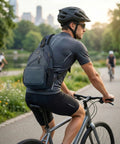 Cyclist wearing Men's Sling Bag Crossbody Backpack on bicycle path in park