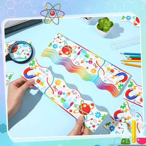 Person holding Colorful Science Bulletin Board Borders Set 72 Feet Scalloped Chemistry Lab Trim on a blue desk