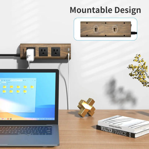Mounted power strip surge protector with USB-C and USB-A, 1800J surge protection, wood finish on wall above desk, laptop shown.