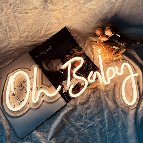 Oh Baby Neon Sign White LED Wall Decor With Dimmable Brightness And Plug In Power Adapter Perfect Nursery Night Light lit on fabric