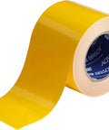 Heavy Duty Polyester Floor Marking Tape In Bright Yellow With Kick Ass Adhesion For Concrete Warehouses And 2 Inch By 100 Foot Roll displayed on a spool.