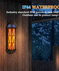 74 LED Flickering Flame Solar Wall Lights Outdoor Sconces Auto On Off Waterproof Lanterns installed on wall in rain