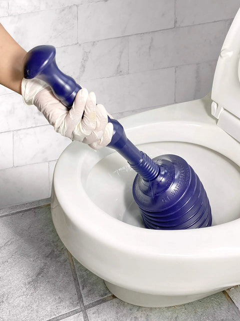 Proven Heavy Duty Bellows Plunger Knocks Out Stubborn Clogs Quick Built With Automatic Air Relief Valve To Prevent Overflow Handles Tight Spots On Toilets Kitchen Sinks And Garbage Disposals Navy Blue in use on a toilet.