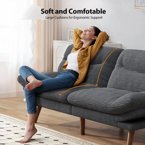 Woman reclining on 66 Inch Corduroy Futon Sofa Bed With Adjustable Backrest And Armrests, in grey, showcasing comfort in small living spaces.