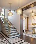 Top Shelf Amber Glass Pendant Light With Vintage Gold Trim For Kitchen Island And Dining Area Height Adjustable Cord, illuminating stairwell.