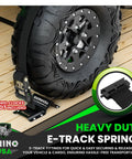 Built Tough Ultimate Heavy Duty E Track Ratchet Tie Downs Set securing vehicle wheel on wooden trailer floor