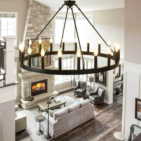 Black Wagon Wheel Chandelier 40 Inch With 20 Lights in living room with high ceilings, providing cozy ambient lighting over a modern space.