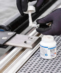 Applying Anti Seize High Tech Metal Free Assembly Paste For Clean DIY And Pro Use NSF Certified Prevents Seizing And Corrosion Safe On Stainless Steel And Food Equipment Extreme Heat Range From -40 F To 2552 F 4.2 Oz to a stainless steel part on equipment.