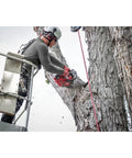 Arborist using M18 FUEL 14-Inch Top Handle Chainsaw Kit with Brushless Powerstate Motor on tree limb from lift