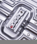 Close-up of TSA lock on all aluminum carry on luggage with TSA locks hard shell spinner suitcase, silver aluminum shell.