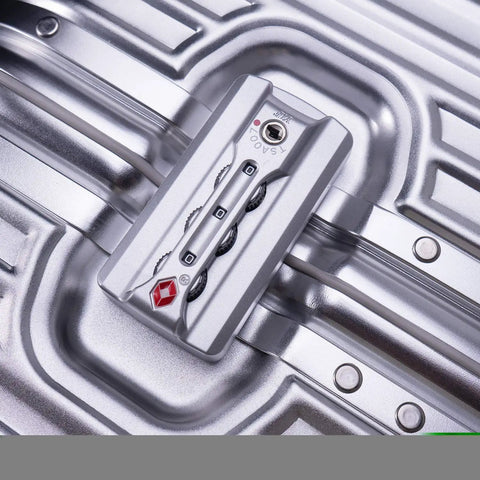 Close-up of TSA lock on all aluminum carry on luggage with TSA locks hard shell spinner suitcase, silver aluminum shell.