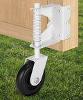 Heavy Duty Gate Wheel With Spring Loaded Gate Caster attached to outdoor wooden gate on grass surface