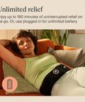 Woman relaxing on sofa wearing Four In One Back Wrap With Heat, Far Infrared, Vibration, And LED Therapy For Epic Lower Back Pain Relief At Home.