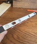 Close-up of Savage Grip 11-Inch Aluminum Torpedo Level With Brightview Technology and four neodymium magnets on tabletop