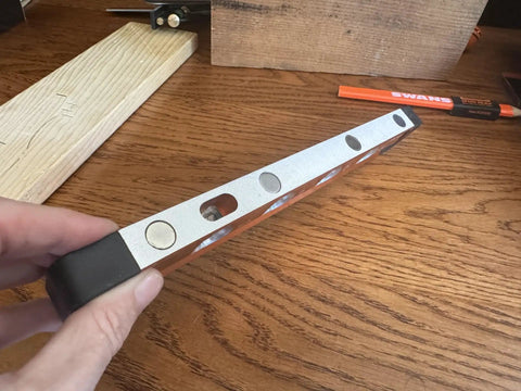 Close-up of Savage Grip 11-Inch Aluminum Torpedo Level With Brightview Technology and four neodymium magnets on tabletop